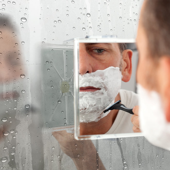 Zadro ZM05 705004415224 environment photo front view mounted on vanity mirror user razor shaving, fogless swivel shower mirror with magnification & suction cup in front of a real life setting