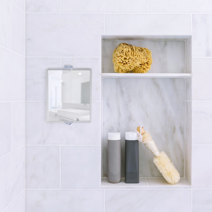 Zadro ZM05 705004415224 environment photo front view mounted on shower wall with bathroom storage, fogless swivel shower mirror with magnification & suction cup in front of a real life setting