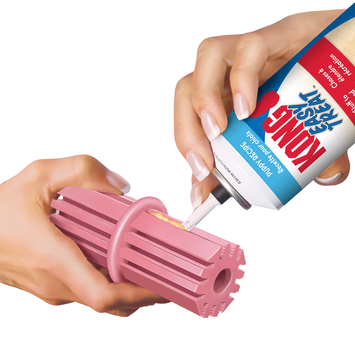 Person applying KONG paste into the ridges of the kong puppy toy