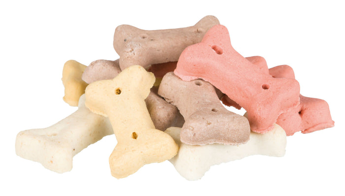 Assorted colored bone-shaped dog treats on a white background